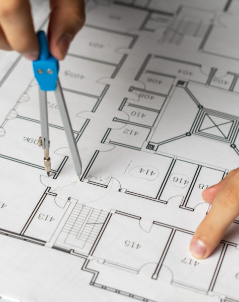 engineer-sketching-building-project-on-a-blueprint-2024-09-17-23-37-40-utc-scaled.jpg