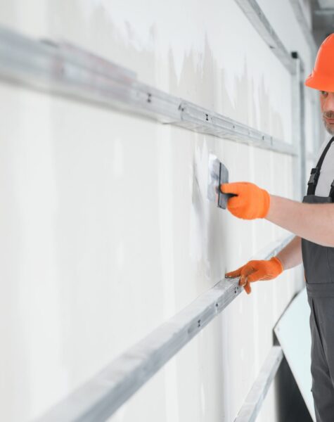 man-drywall-worker-using-trowel-for-plasterer-putt-2023-11-27-05-02-14-utc-scaled.jpg