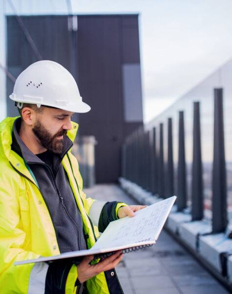 man-engineer-standing-on-construction-site-holdin-2024-10-18-08-43-29-utc-scaled.jpg
